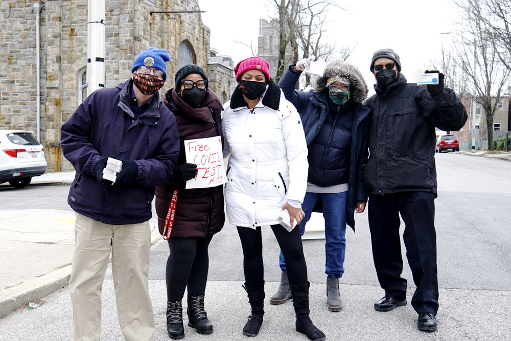 Pratt Library staff and volunteers handing out free at-home COVID-19 test kits