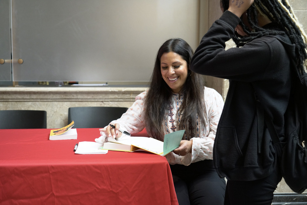 Author Yamile Saied Méndez signs a copy of Furia