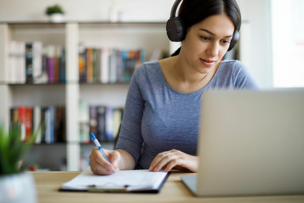 woman studying at home for her diploma