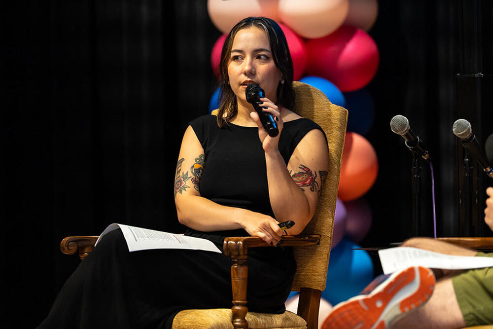 Emma Kidwell speaking on stage at the 2026 Indie Video games Fest.
