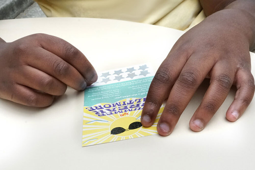 close-up of hands using a Summer Break scratch off card