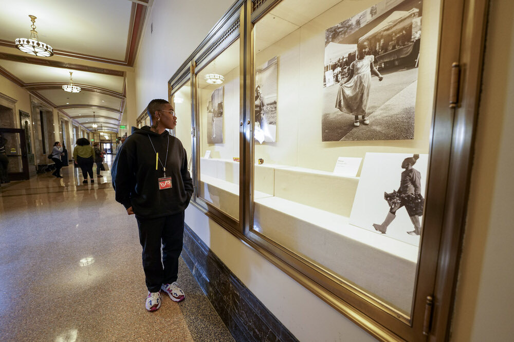 SHAN Wallace Artist in Residence at Pratt Library looking at exhibit