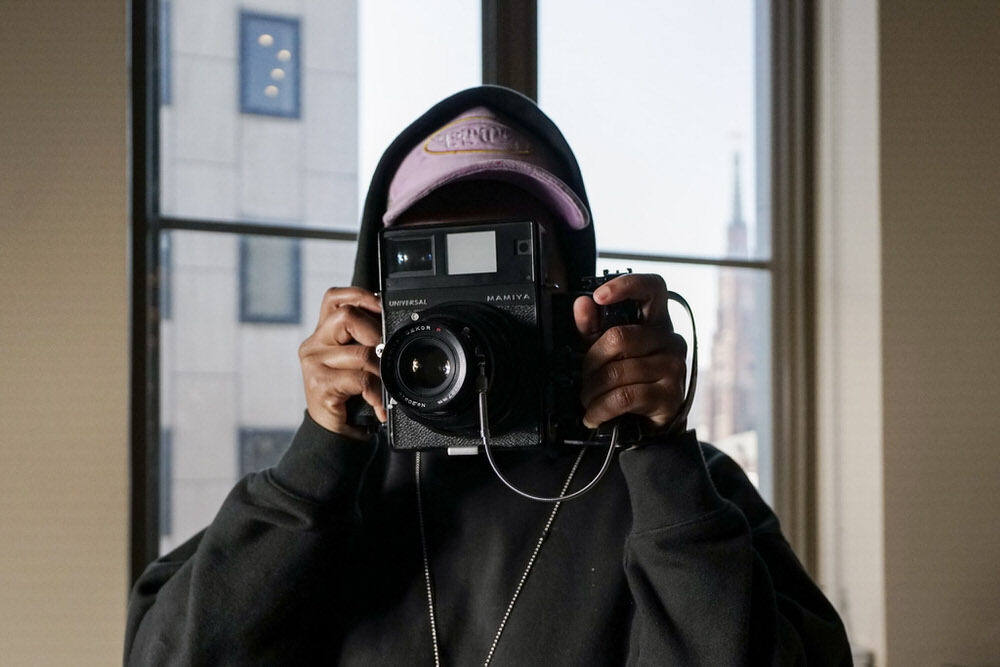 SHAN Wallace Artist in Residence at Pratt Library with camera