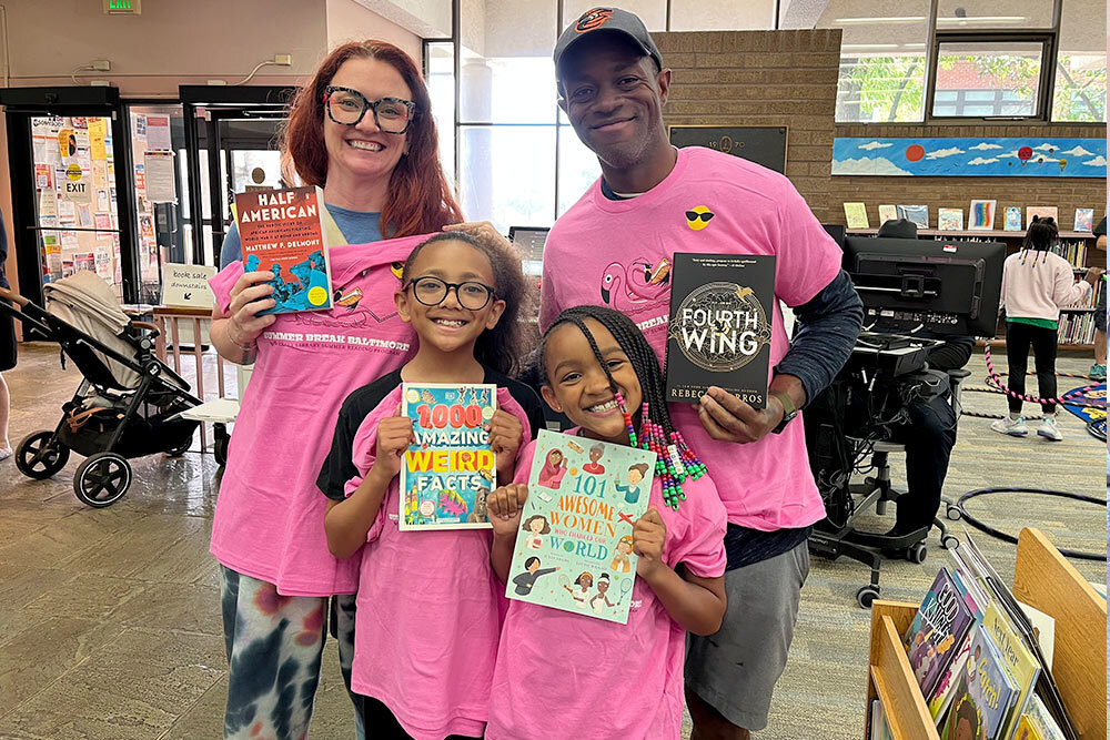 Summer Break Baltimore 2025 - a family of four with their books and t-shirts