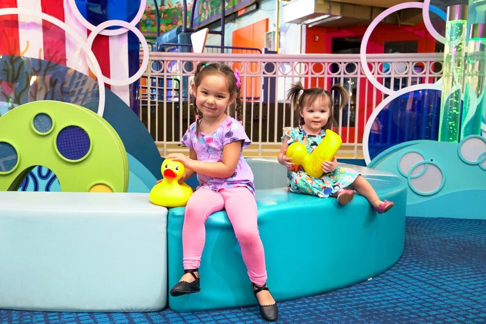 Tickets to Discovery - Port Discovery interior and two girls with rubber ducks