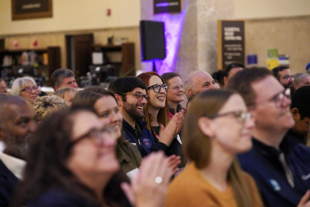 audience clapping and smiling at a Pratt Library event