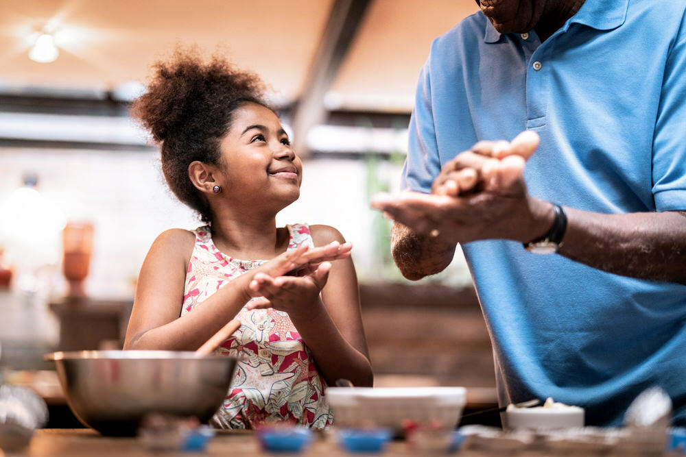 cooking together - child and dad or grandfather baking in kicthen