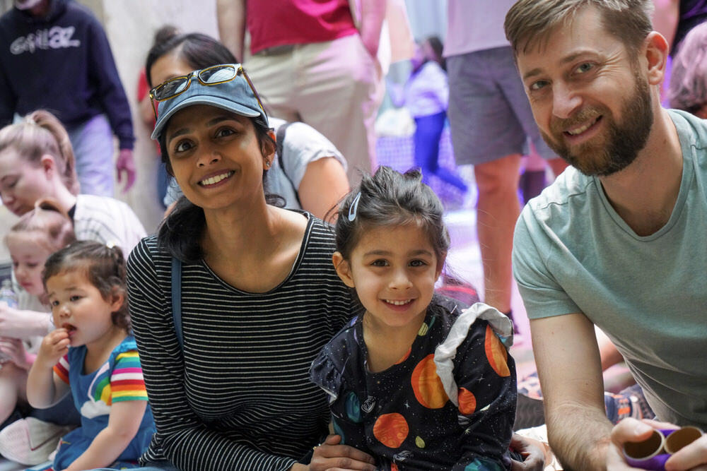 families at a Pratt Library event - parents and children on the floor