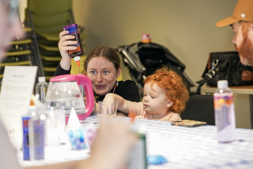 librarian and young child making crafts.