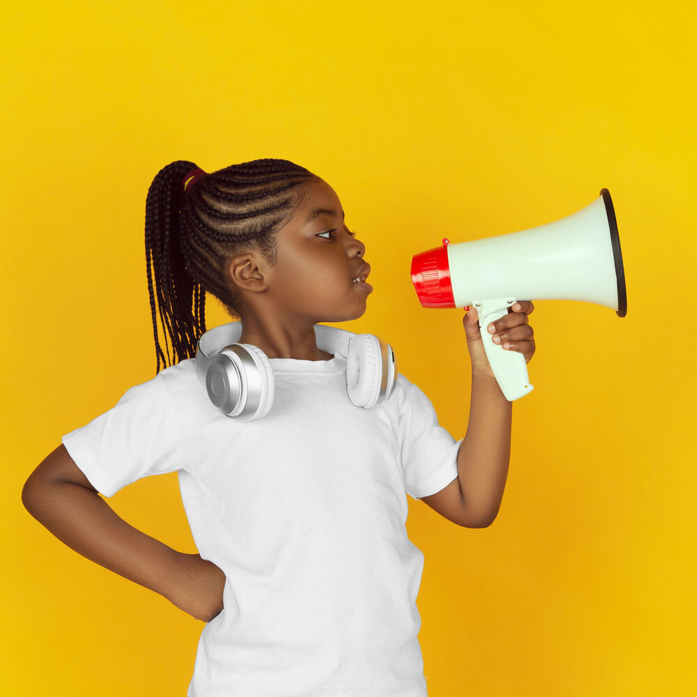 girl with a megaphone on a yellow background