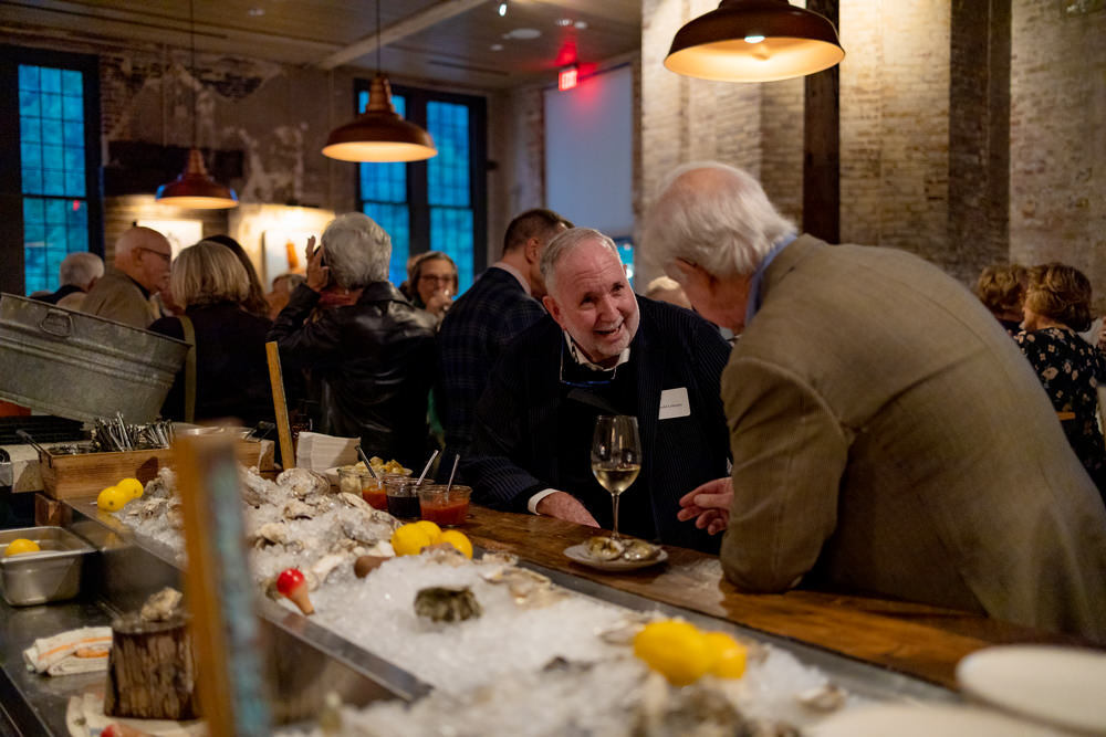 Arnold Lehman private event - chatting at an oyster bar