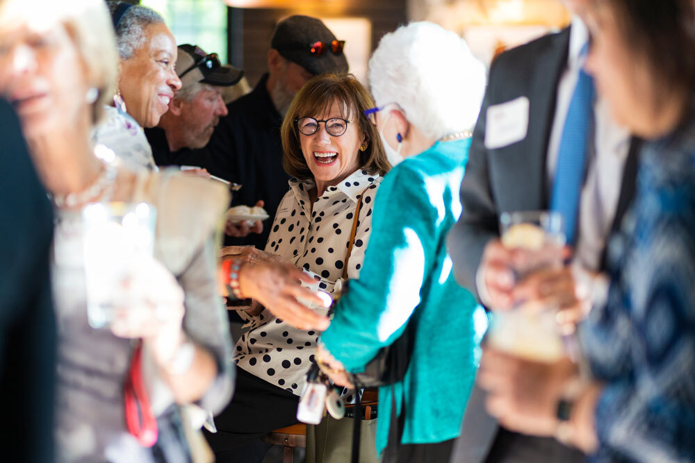 Pratt Society event crowd polka dots woman big smile crop 3x2