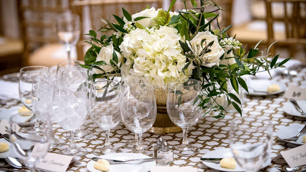 event table set with flowers, glasses, place settings