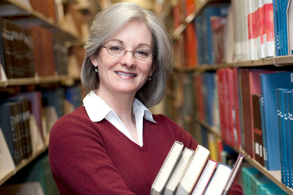 Volunteer - older woman with books