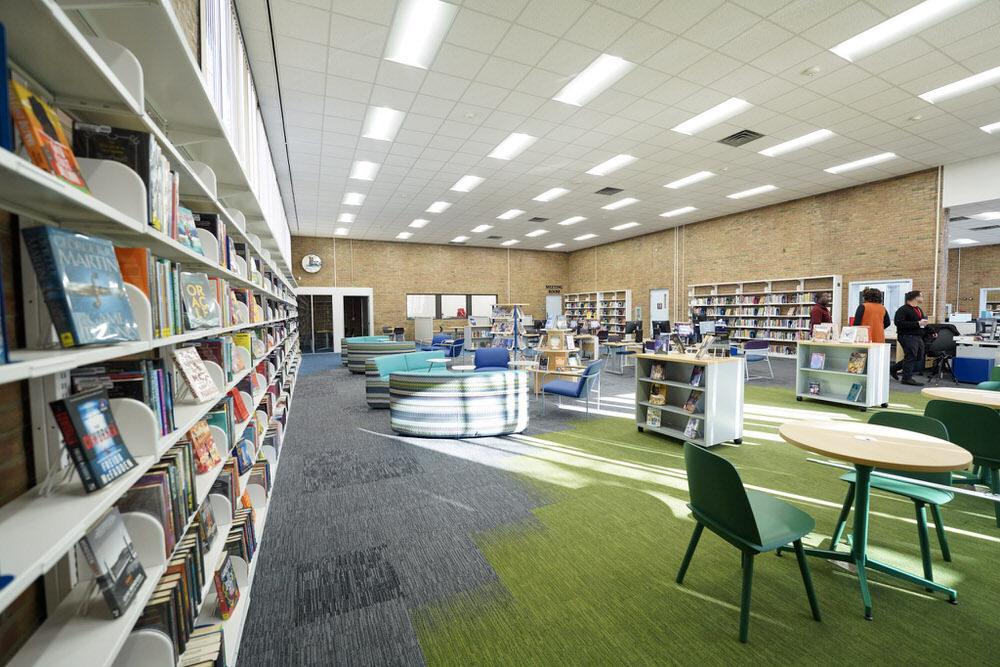 Brooklyn Branch renovated wide view with bookshelves, new lights and carpeting