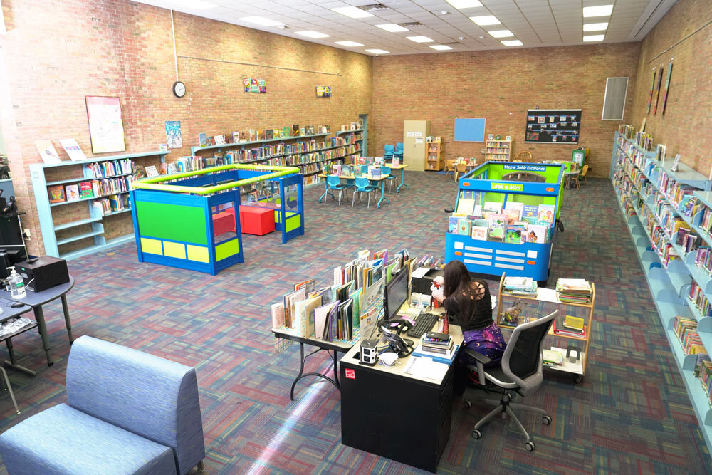 Brooklyn room from above showing play furniture for children, seating, bookshelves, and a staff desk