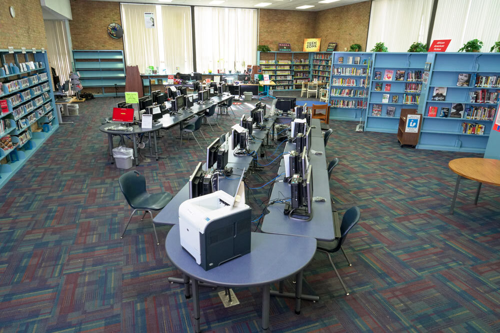 Brooklyn interior showing computers on tables, bookshelves , and woindows