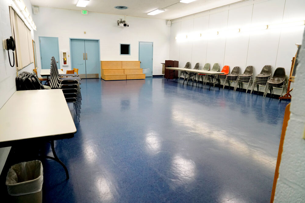 Brooklyn meeting room showing digital projector, tables and chairs along the side