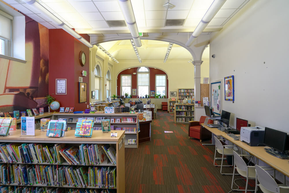 Canton interior view of library rooms with arched doorways and bookshelves