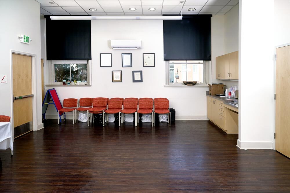 Canton meeting room - wide view facing windows showing placement of kitchen cabinets