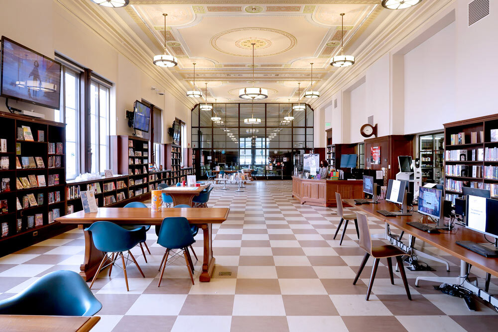 Central Library Teen Center reading room with tables and chairs, books, checkered floors and decorative ceiling