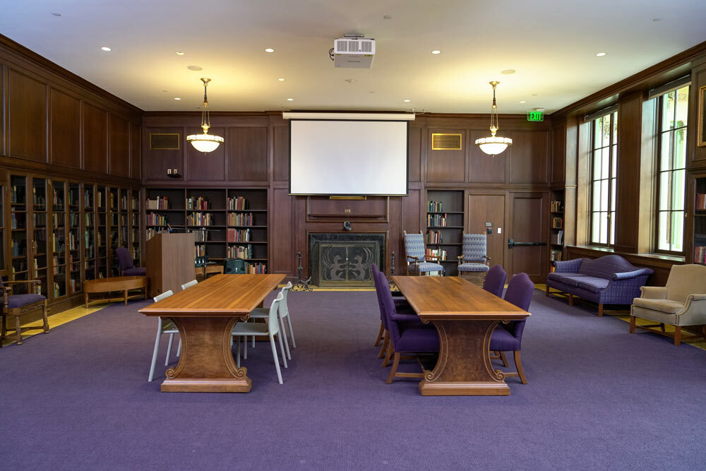 Poe Room at the Central Library - room view facing the projection screen with two long tables