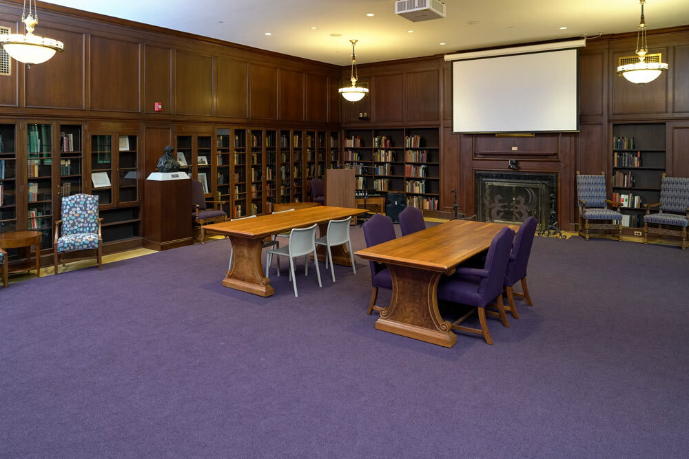 Poe Room at the Central Library - room view with wooden tables, bookshelves, and a projection screen