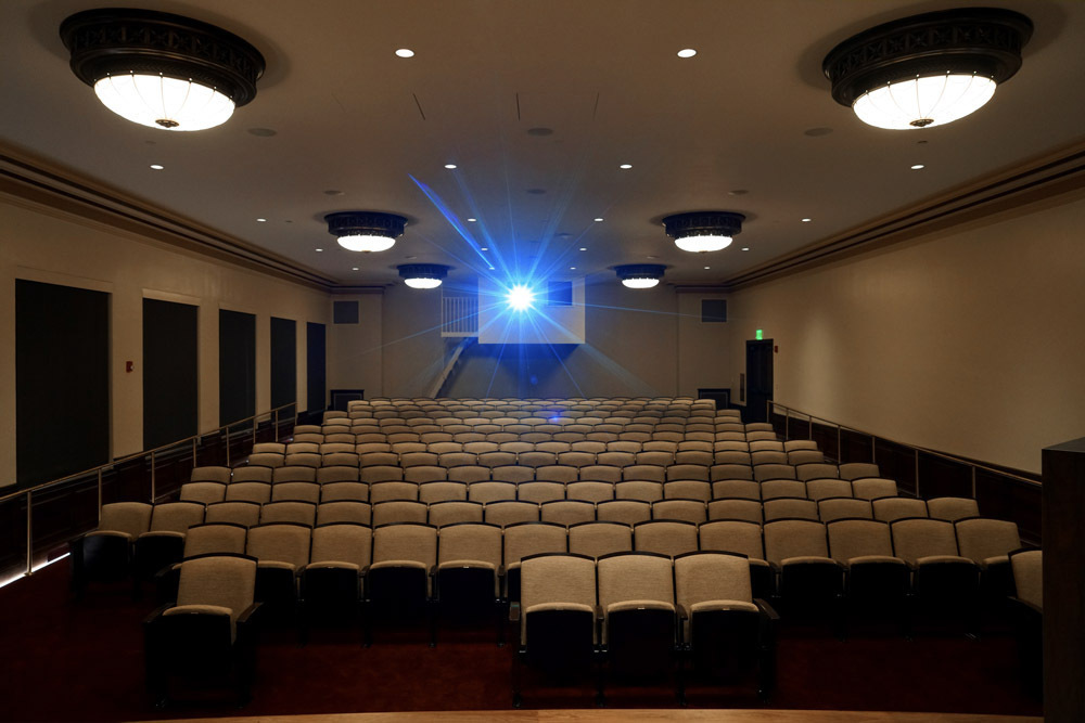 Wheeler Auditorium at Central Library - empty seats in a darkened room with blue light from a projector