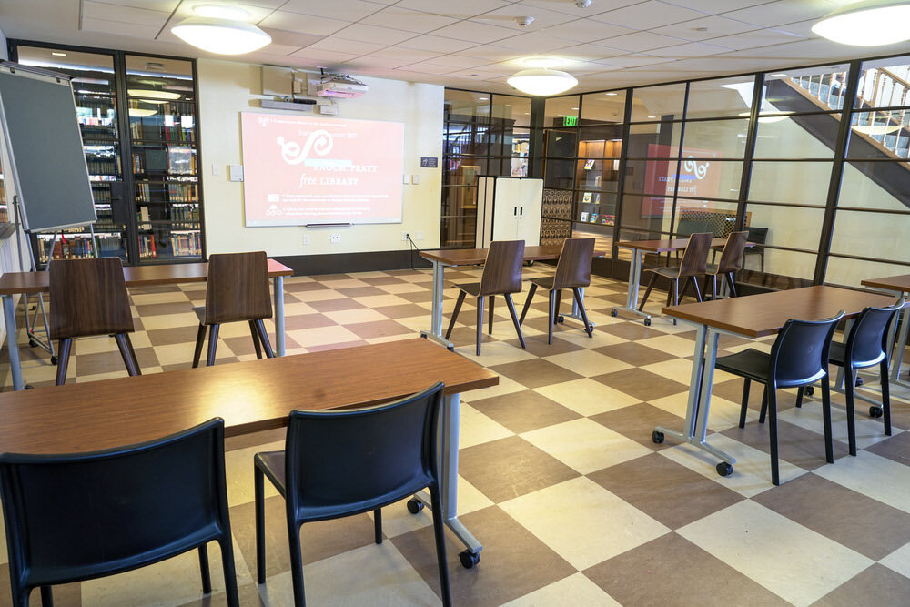 meeting room 1801 at the Central Library - a glass enclosure with tables chairs, and a projection screen