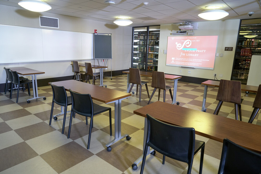 meeting room 1801 at the Central Library - a glass enclosure with tables chairs, a projection screen, and a whiteboard