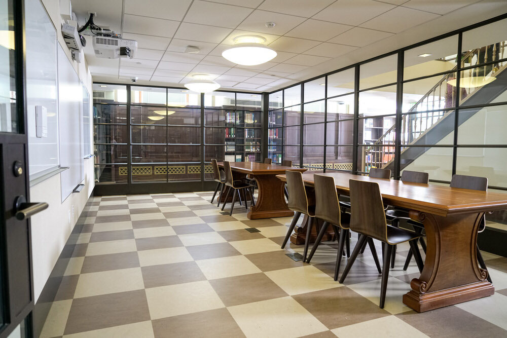 meeting room 1802 at the Central Library - tables, chairs, a checkerboard floor, glass walls, and whiteboards