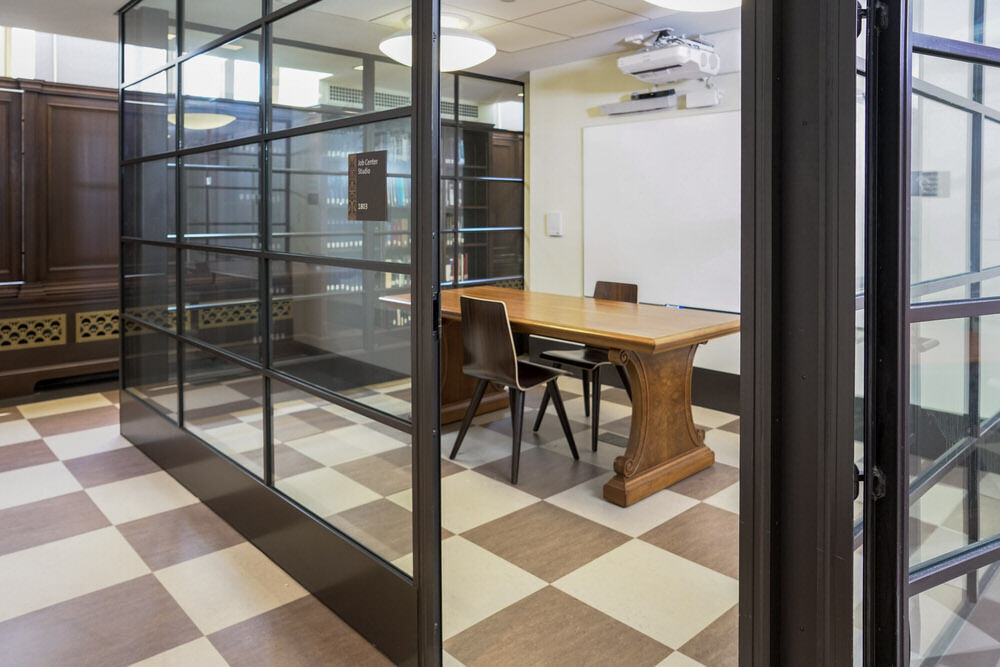 meeting room 1803 at the Central Library - open door in glass walls to a table, chairs, a checkerboard floor, and whiteboard