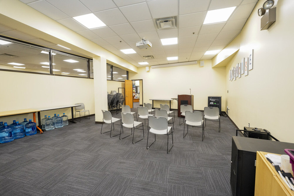 Cherry Hill meeting room showing a wide view with chairs facing a podium with microphone