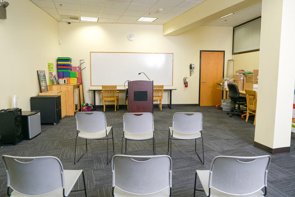 Cherry Hill meeting room showing chairs facing a whiteboard, and podium with microphone