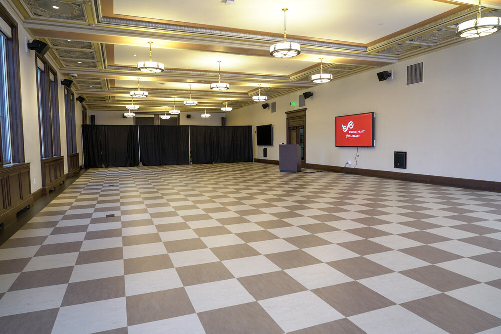 Creative Arts room at the Central Library - empty room with checkerboard floor, digital screen, curtained off back area