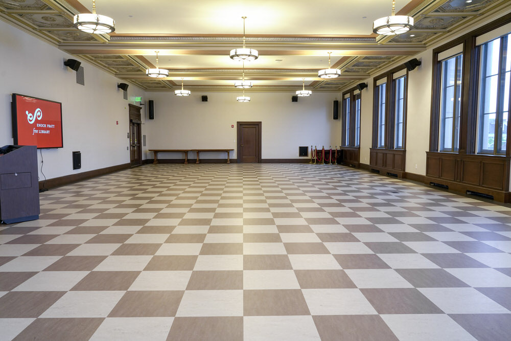 Creative Arts room at the Central Library - empty room with checkerboard floor, windows, a screen, podium