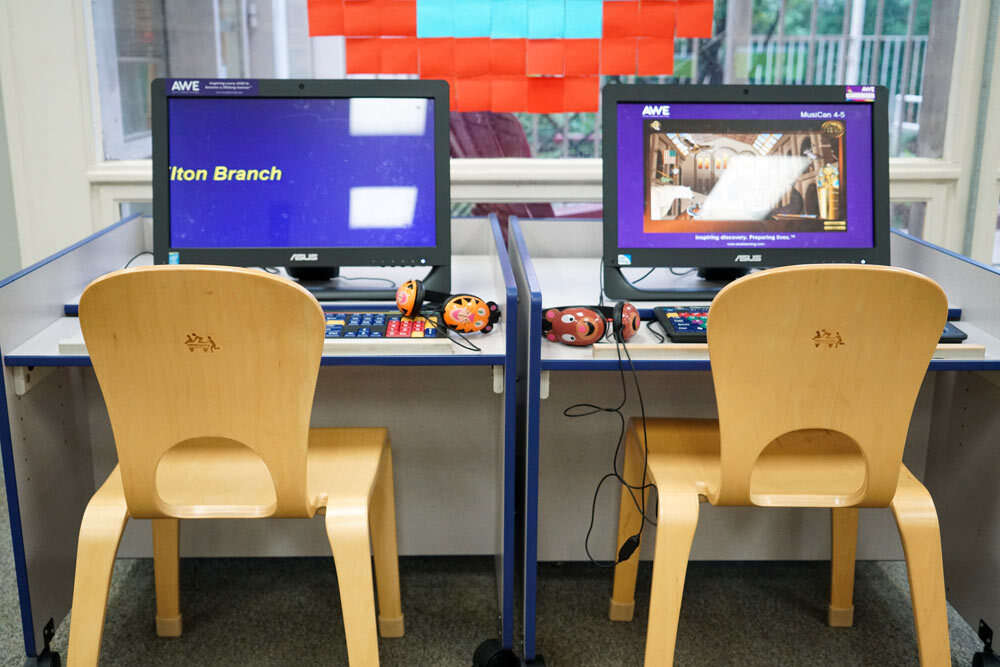 Hamilton - kids' computers showing AWE screens and kids' chairs