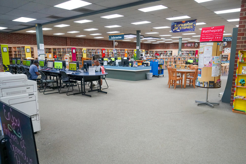 Hamilton wide room view with bookshelves and people using computers