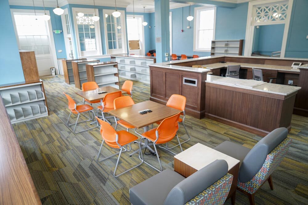 Hampden room with furniture and empty shelves before reopening