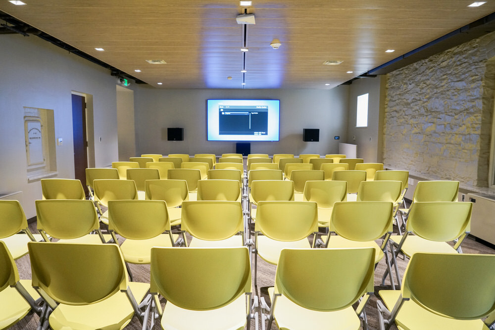 Hampden meeting room - chairs set up facing the digital projection screen