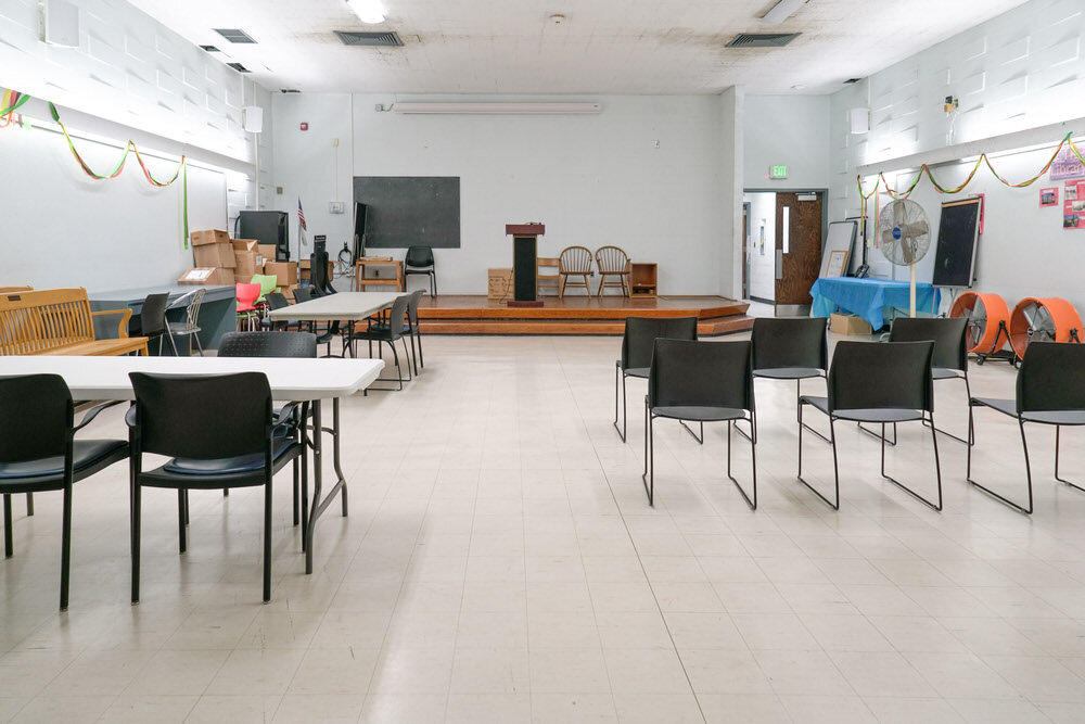 Herring Run meeting room - chairs and tables, facing forward toward the stage