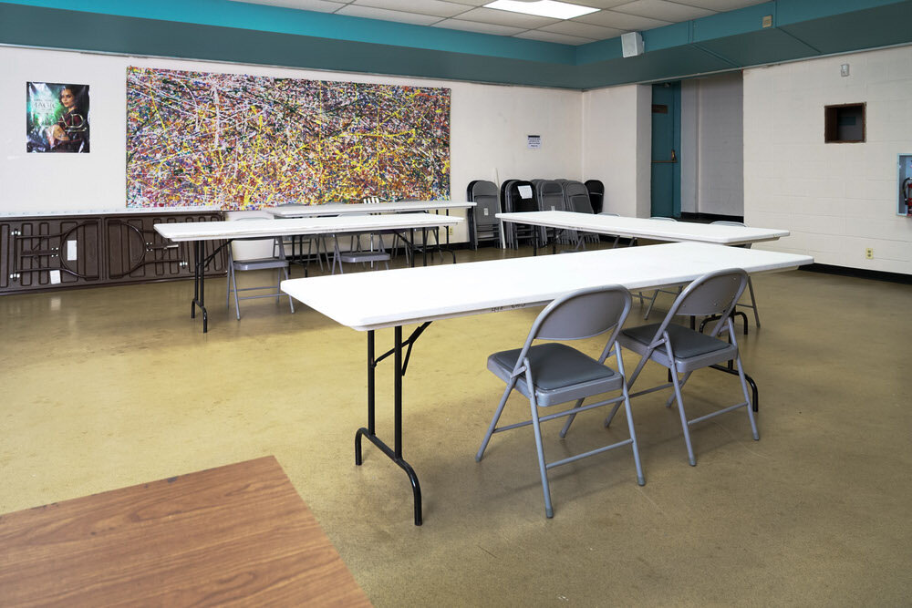 Light Street meeting room - tables and chairs, facing abstract art on the wall
