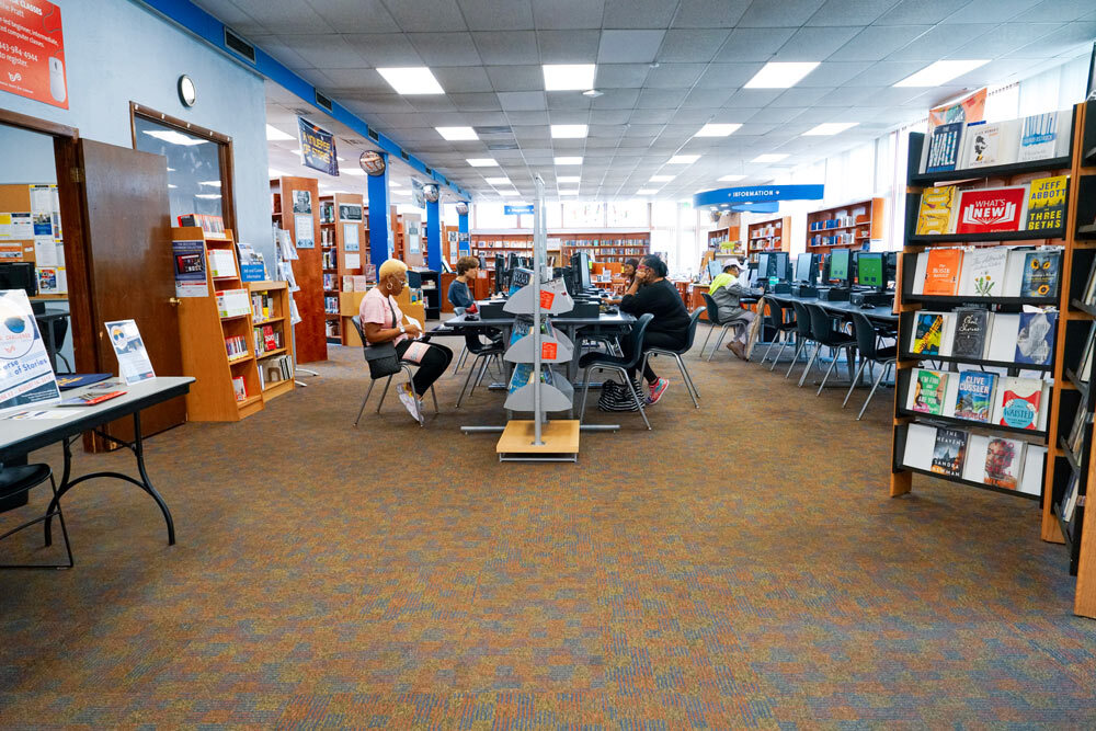 Northwood room view with people using computers, and bookshelves