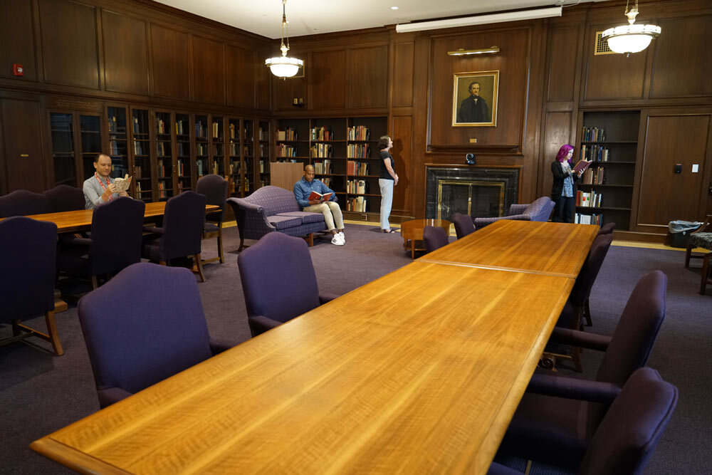 Poe Room at the Central Library - people reading, a long wooden table, Poe's portrait painting