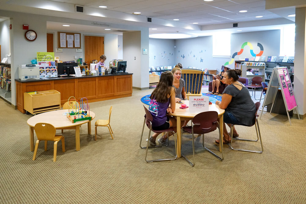 Roland Park desk and people at a table