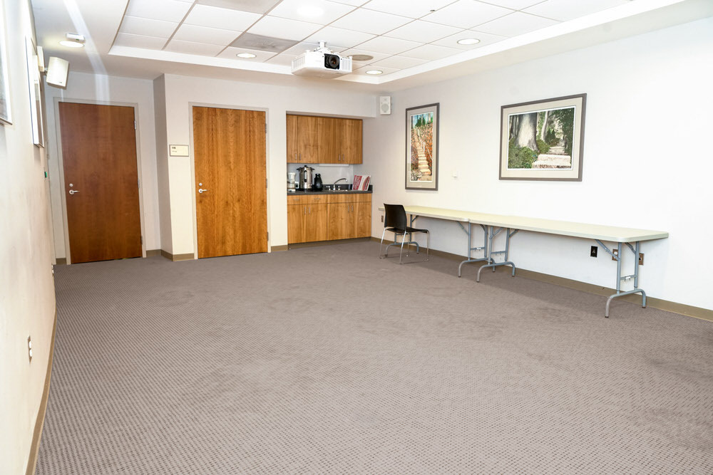 Roland Park meeting room - corner view with folding table and artwork