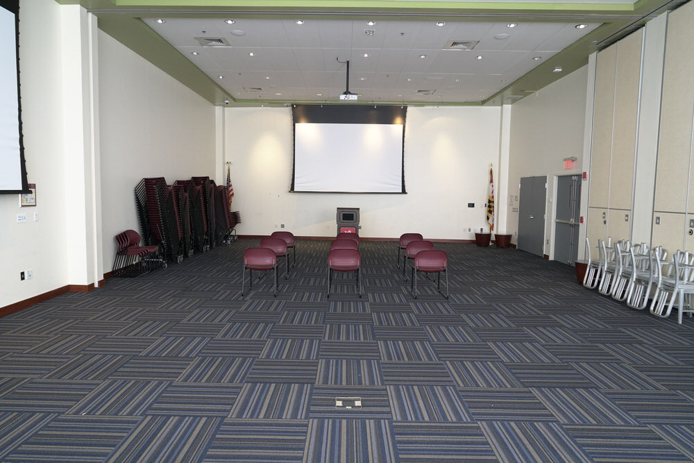 Southeast large meeting room - auditorium facing the screen, with a wide view of the floor and chairs