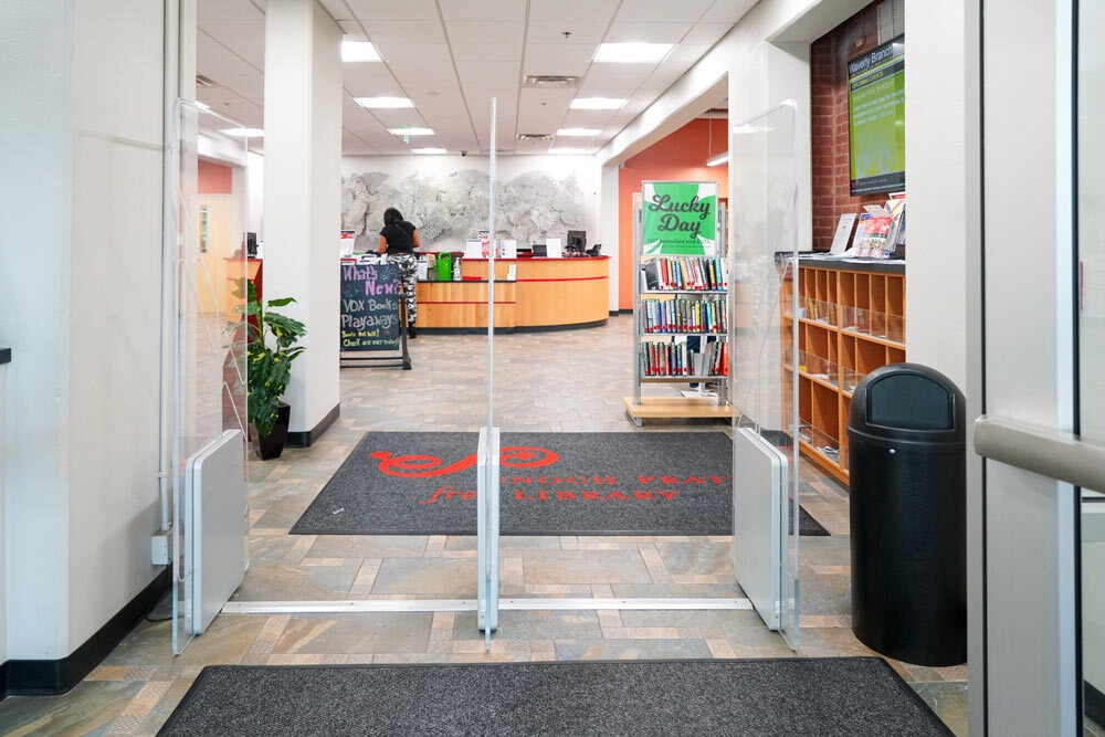 Waverly interior entrance showing a Lucky Day sign, desk with sculptural artwork, and displays