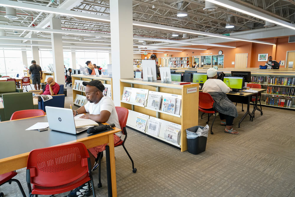 Waverly - people using computers and browsing, newspapers on display