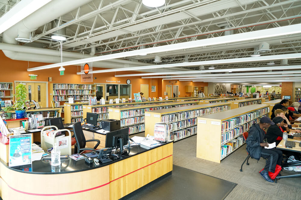 Waverly room view with bookshelves, desk, and people using computers